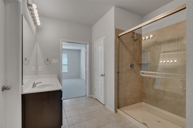 bathroom with vanity, a shower with shower door, and tile patterned floors