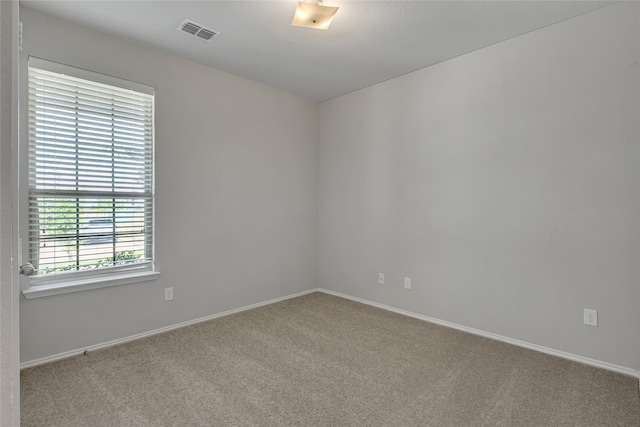 spare room featuring light colored carpet