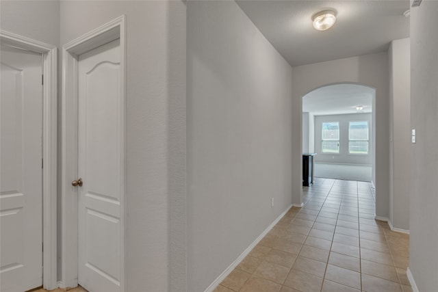 corridor featuring light tile patterned flooring