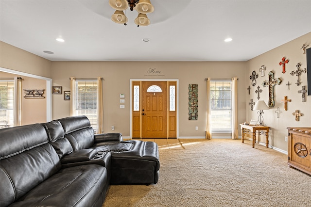 carpeted living room featuring ceiling fan