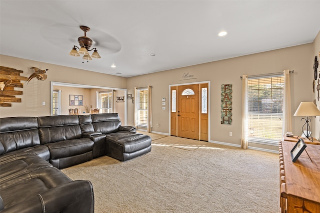 carpeted living room featuring ceiling fan