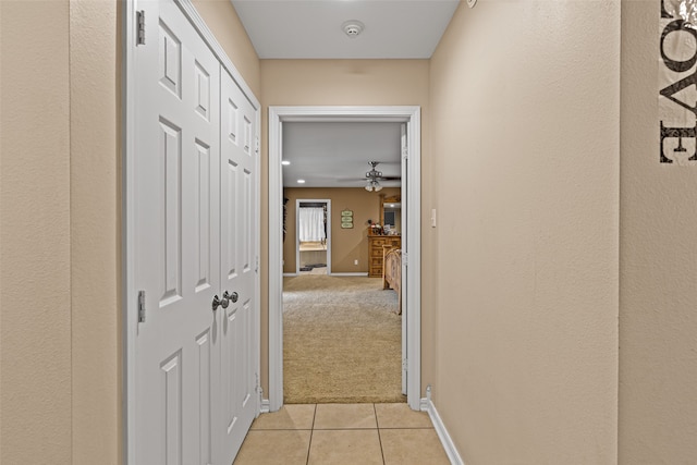 hall featuring light colored carpet