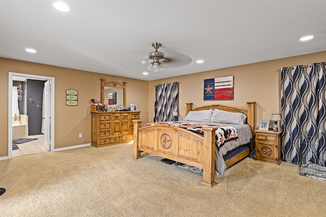 carpeted bedroom featuring ceiling fan and ensuite bath