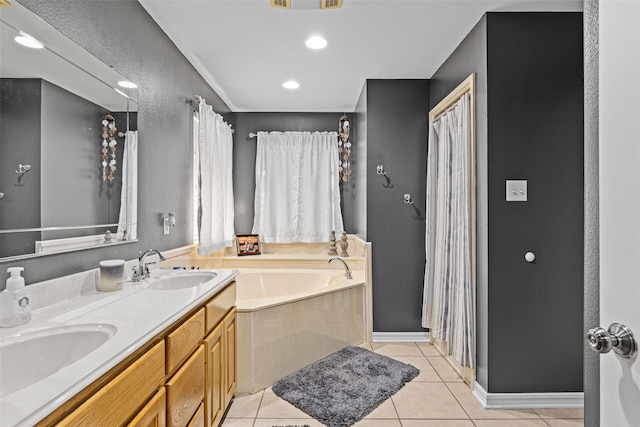 bathroom with vanity, a tub, and tile patterned floors