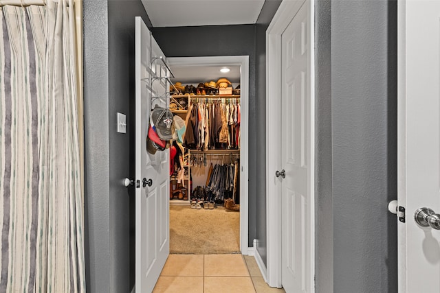 walk in closet featuring light tile patterned flooring