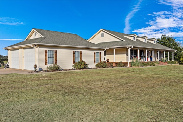 view of front of home featuring a porch, a front lawn, and a garage