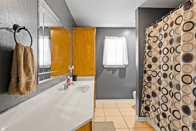 bathroom featuring toilet, vanity, and tile patterned floors