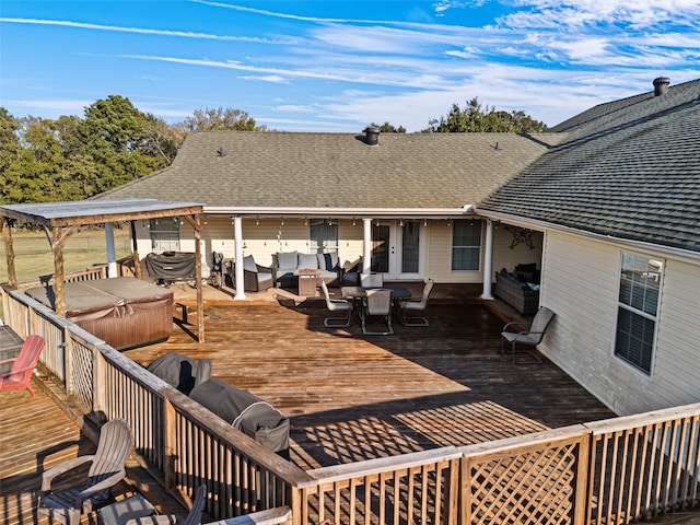 wooden deck featuring a hot tub