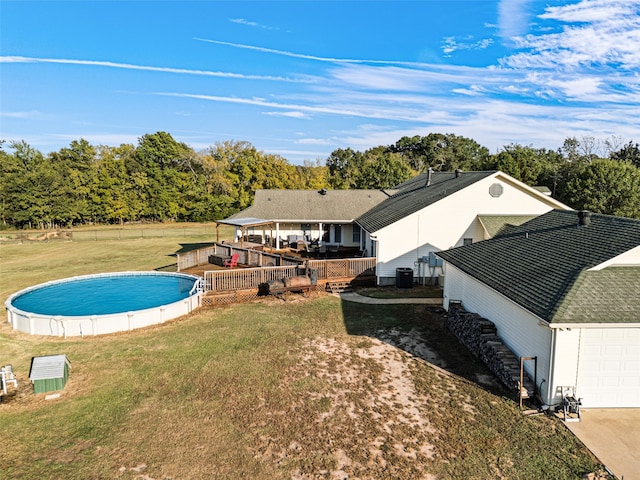 view of pool featuring a wooden deck and a lawn