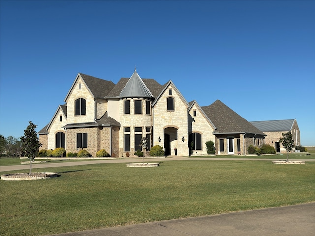 french country home featuring a front lawn