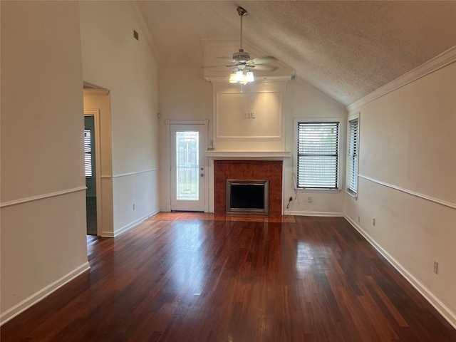 unfurnished living room featuring lofted ceiling, a textured ceiling, ornamental molding, dark hardwood / wood-style floors, and ceiling fan