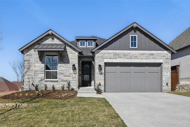 view of front of property featuring driveway, a garage, stone siding, and a front yard