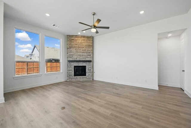 unfurnished living room with wood finished floors, a ceiling fan, visible vents, and recessed lighting