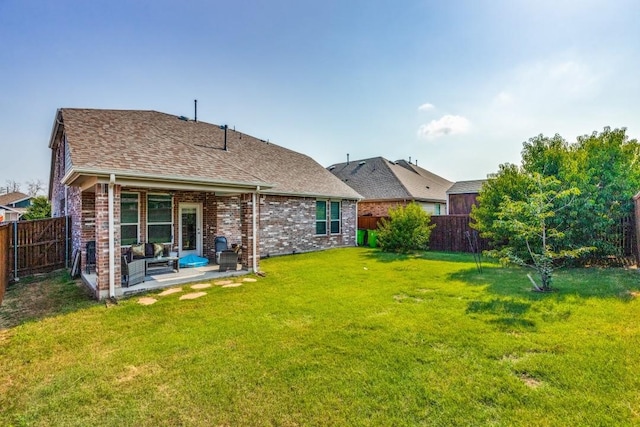 back of property featuring a yard and a patio area