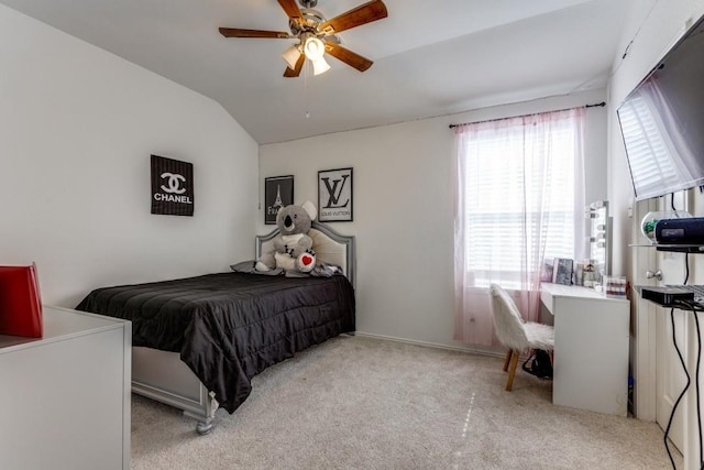 carpeted bedroom featuring ceiling fan and vaulted ceiling