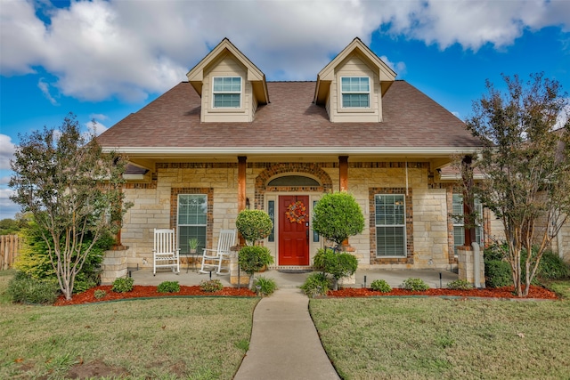 view of front of house featuring a front yard and covered porch