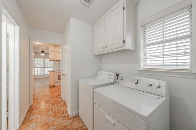 clothes washing area featuring light tile patterned flooring, cabinets, washer and dryer, and ceiling fan