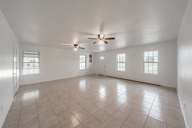 tiled spare room featuring ceiling fan