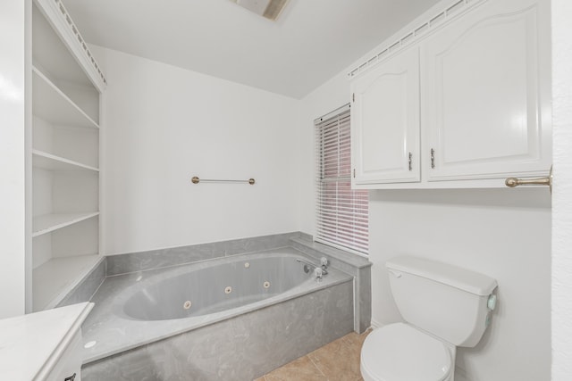 bathroom featuring toilet, tile patterned flooring, and a tub