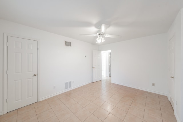 unfurnished room with light tile patterned flooring and ceiling fan