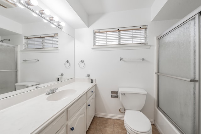 full bathroom featuring vanity, enclosed tub / shower combo, tile patterned flooring, and toilet