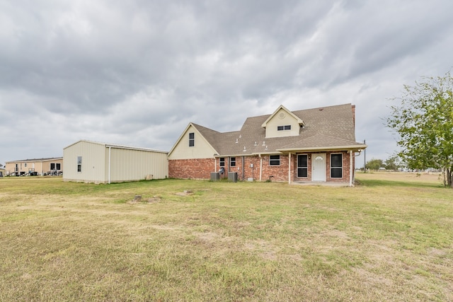 back of property with a lawn