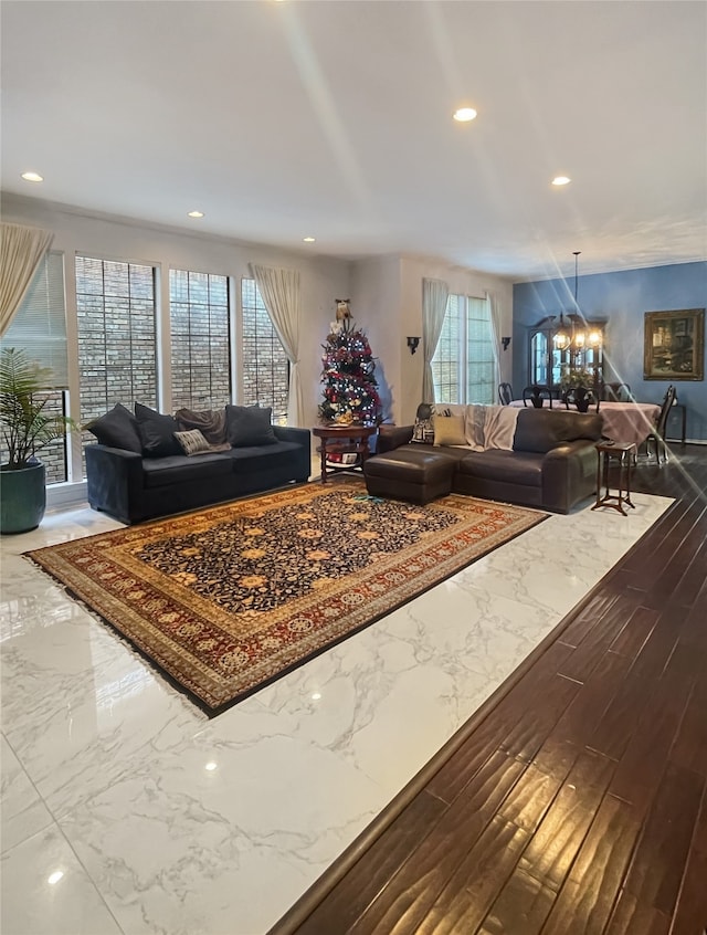 living room with hardwood / wood-style flooring, a notable chandelier, and a healthy amount of sunlight