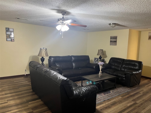 living room with ceiling fan, a textured ceiling, and dark hardwood / wood-style flooring