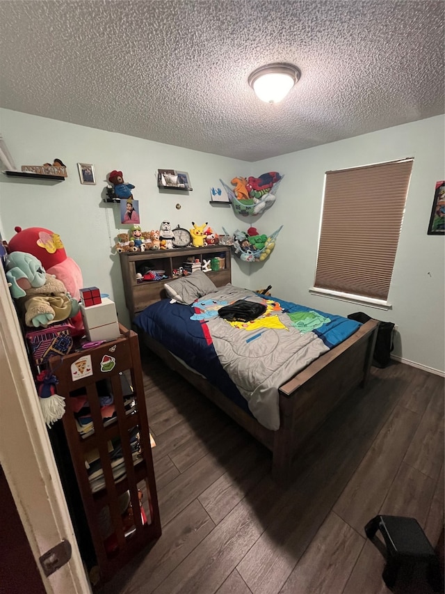 bedroom featuring dark hardwood / wood-style floors and a textured ceiling