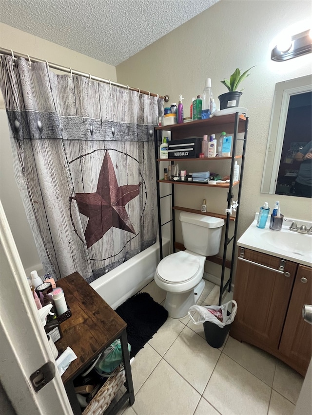 full bathroom with shower / bath combination with curtain, vanity, a textured ceiling, tile patterned flooring, and toilet