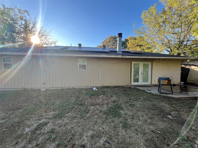 rear view of house featuring a patio and french doors