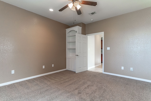 unfurnished bedroom with light colored carpet and ceiling fan