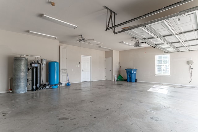 garage with a garage door opener and ceiling fan