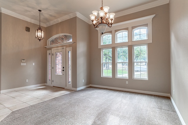 entryway with a high ceiling, an inviting chandelier, light colored carpet, and ornamental molding