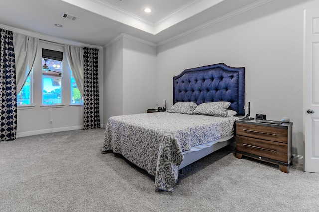 bedroom with carpet flooring, ornamental molding, and a raised ceiling