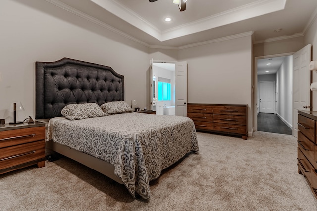 bedroom with ornamental molding, a tray ceiling, light colored carpet, and ceiling fan