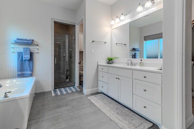 full bathroom with separate shower and tub, toilet, tile walls, tile patterned flooring, and vanity