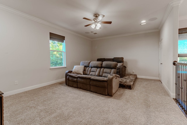 living room with ceiling fan, light colored carpet, crown molding, and plenty of natural light