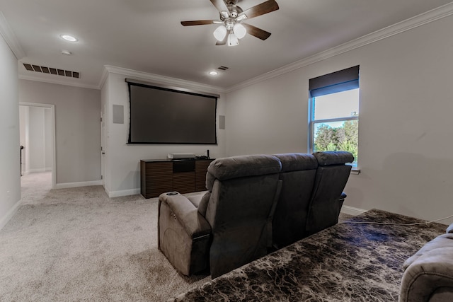 carpeted home theater room featuring ceiling fan and ornamental molding