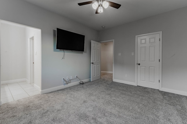 unfurnished bedroom featuring ceiling fan and light carpet