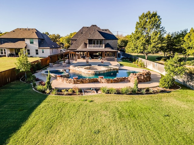 view of pool featuring a lawn, an in ground hot tub, and a patio area