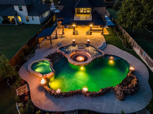 view of swimming pool with a lawn, an in ground hot tub, and a patio area