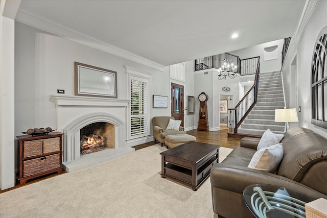 living room with an inviting chandelier, hardwood / wood-style flooring, and ornamental molding