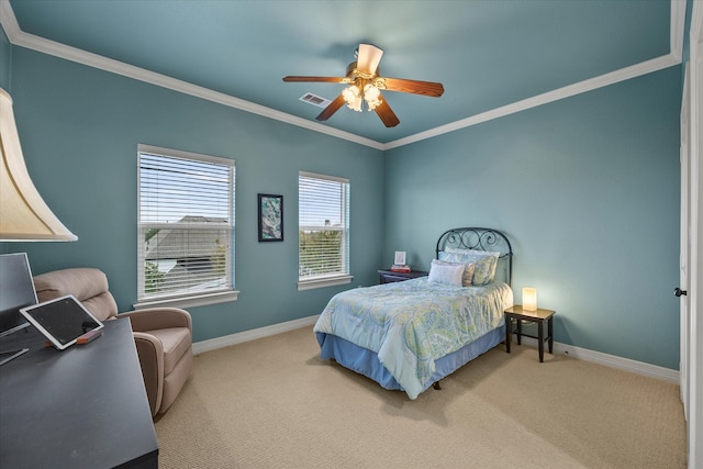 carpeted bedroom with ceiling fan and ornamental molding