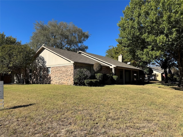 view of side of property with a yard