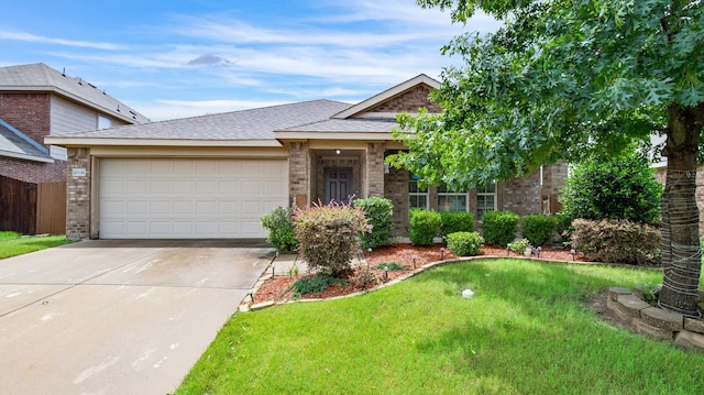 view of front of property featuring a garage and a front lawn