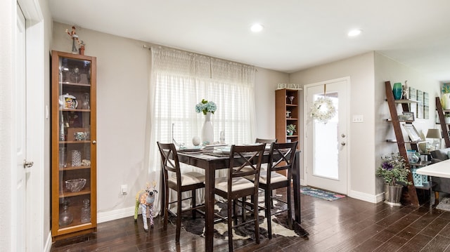 dining space with dark hardwood / wood-style floors