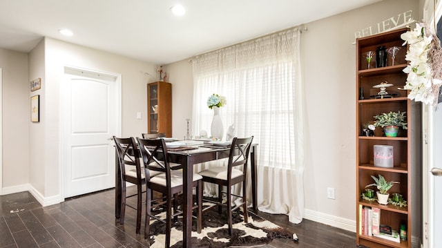 dining space with dark hardwood / wood-style floors