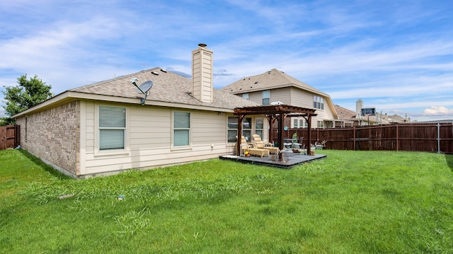 back of property with a yard, a pergola, and a patio area