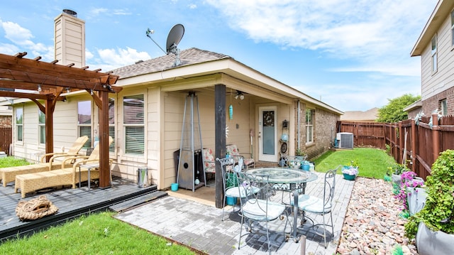 rear view of house featuring central AC unit, a wooden deck, a patio, and a pergola